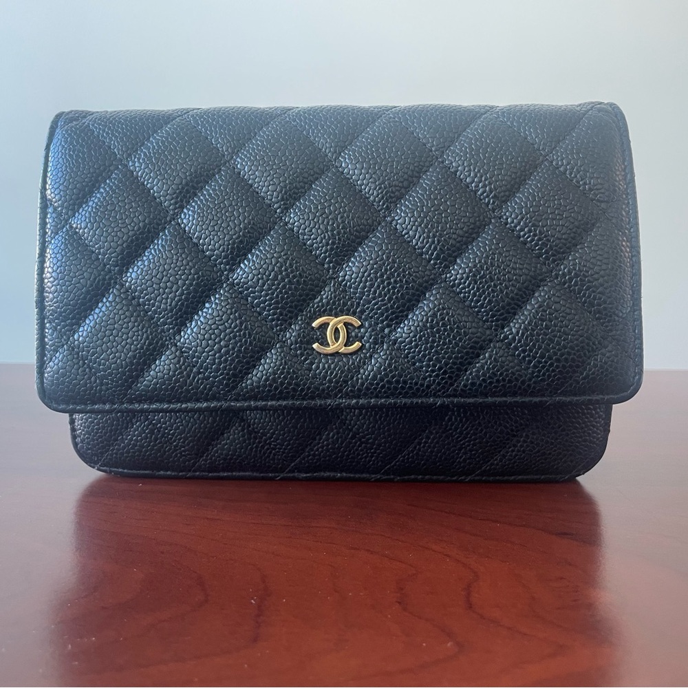 CHANEL Quilted Black Clutch with Gold Emblem